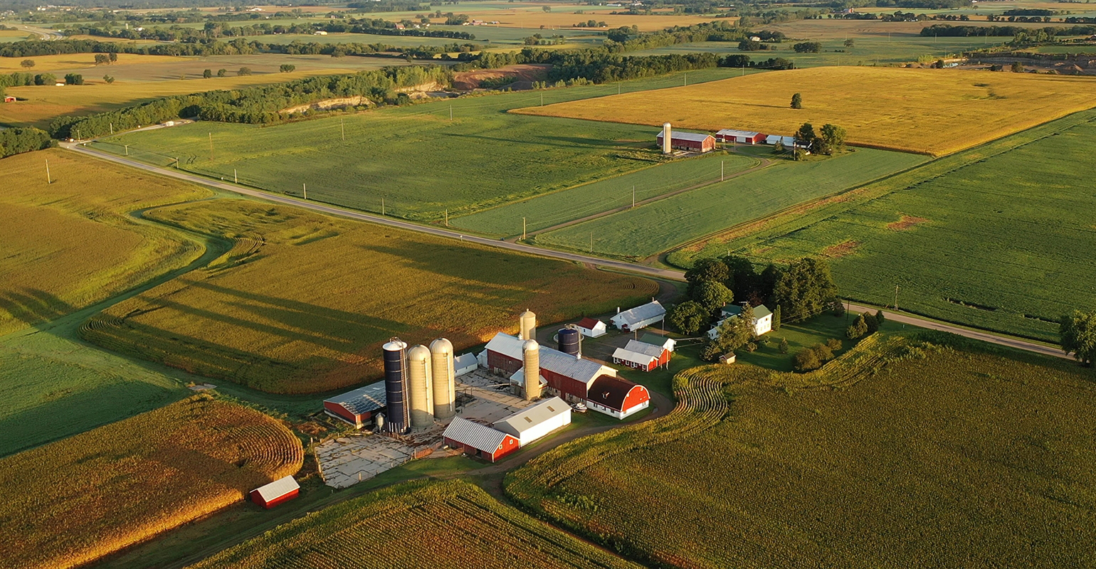 Agricultural drones over farm field at sunset